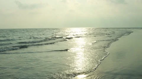 Ocean Waves Gently Lapping on Sandy Beach at Sunset - Tranquil Seascape Stock Footage 239172836