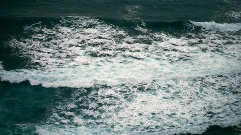 Ocean waves gently roll in at the beach. Video stock 88342913