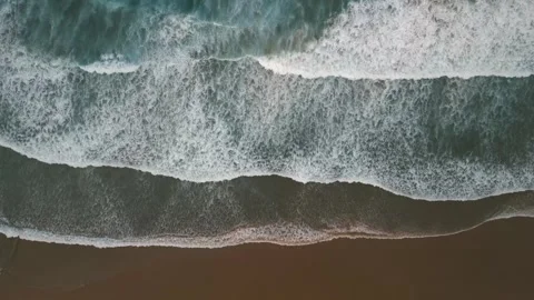 Ocean waves gently rolling onto sandy beach Stock Footage 311766058