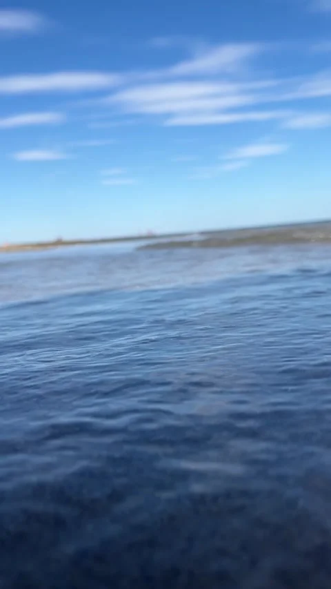 Ocean waves gently rolling onto sandy beach Stock Footage 329319772