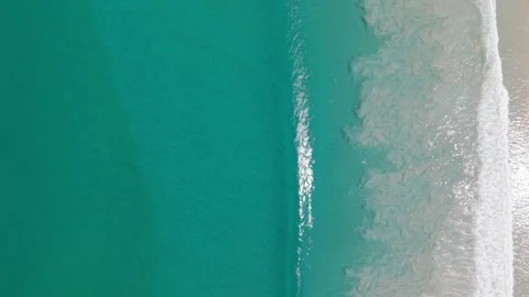Ocean waves gently rolling onto sandy beach, aerial view of shoreline Stock Footage 342313160