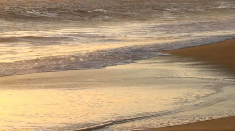 Ocean waves glow in the sunset on a Los Cabos, Mexico beach Stock Footage 917044