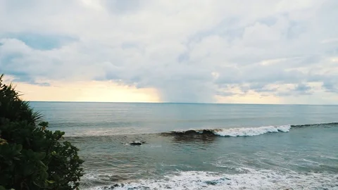 Ocean waves go one by one to the coast of the tropical island on a cloudy day Stock Footage 88260558