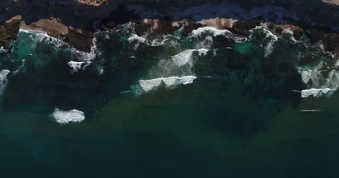 Ocean waves go to the shore of the sand. The view from the top, the copter takes Stock Footage 107359137