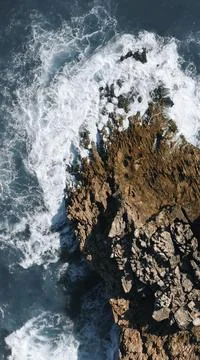 Ocean waves hit the rock Stock Photos