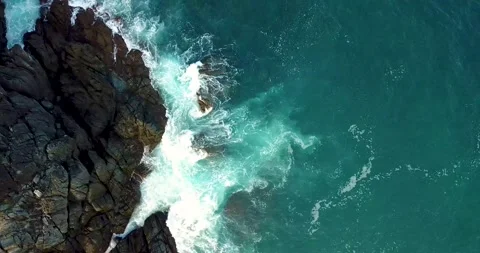 Ocean waves hit rocks in top view drone. Stock Footage 130651448