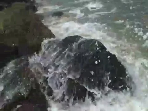 The ocean waves hit the rocks very hard, near the beach Video stock 163683648