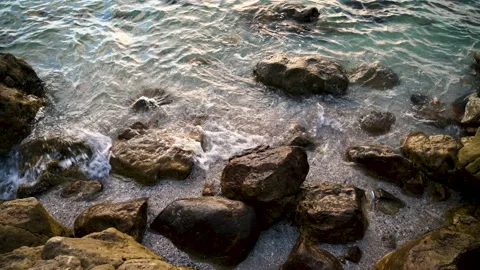 Ocean waves hit the shore and hit the rocks.	 Stock Footage 224341404