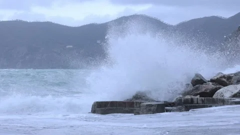 Ocean waves hitting against the rocks on a stormy day Stock Footage 166479359