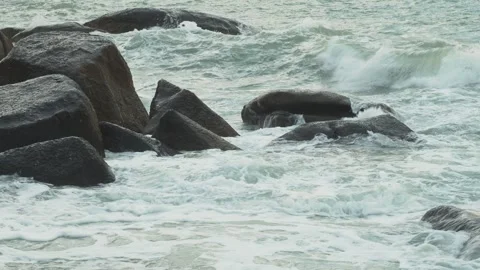 Ocean waves hitting big stones with sea foam Stock Footage 331229610