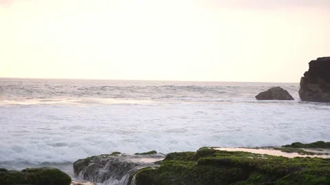 Ocean waves hitting the cliffs. Calm sunset on an island Stock Footage 276724322