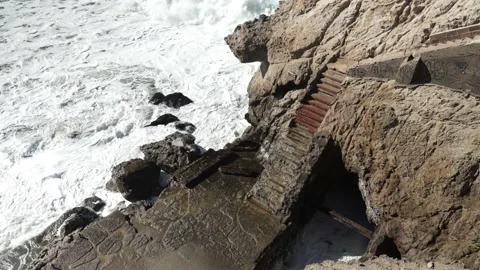 Ocean Waves Hitting Eroded Stone Staircase, Sutro Baths California Stock Footage 145456693