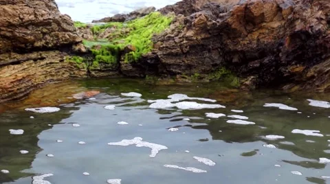Ocean waves hitting rocks   side pool beach moss beach Stock Footage 66557376