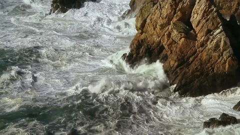 Ocean waves hitting rocky walls. Strong tides in a stormy weather. Video stock 99059695