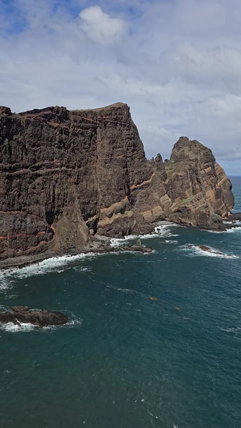 Ocean waves hitting volcanic cliffs at Ponto de Vista, São Lourenço Peninsula Stock Footage 310025520