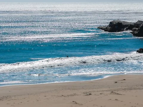 Ocean waves lap against the sandy shore near Franklin Point in California Stock Photos
