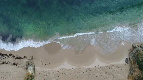 Ocean waves lapping birdseye view Stock Footage 84310011
