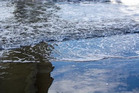 Ocean Waves Lapping at the Shore Stock Photos