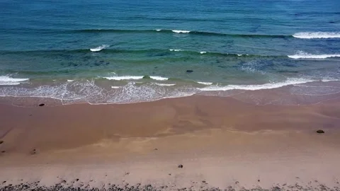 Ocean waves line and sand meeting in the middle walking through drone footage Stock Footage 209194337