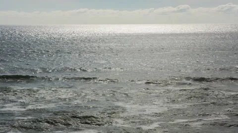 Ocean waves looking into glare from sun to the horizon Stock Footage 40524356