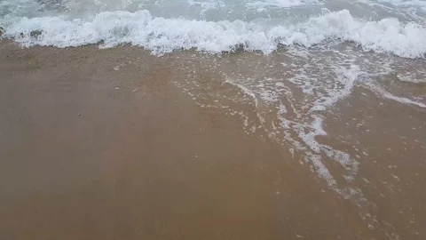Ocean waves moving back and forth over sandy shore land. Stock Footage 115083315