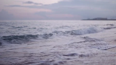 Ocean waves moving on beach on cloudy day Stock Footage 324755645