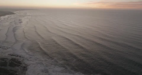 Ocean waves opening toward a glowing horizon off Casablanca Video stock 347845427