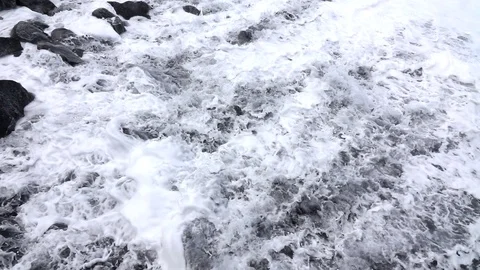 Ocean waves over black rock slow motion Stock Footage 103988299