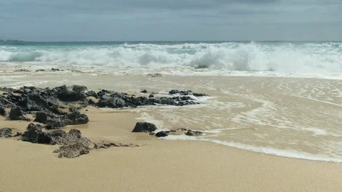 Ocean waves over sand beach in Fuertevenura Stock Footage 76883198