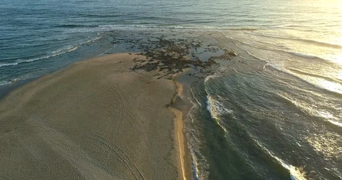 Ocean waves passing over rock pools at sunset 스톡 동영상 110886654
