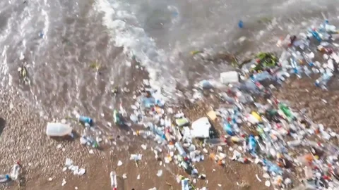 Ocean Waves Push Plastic Waste onto the Sandy Beach Stock Footage 299682121