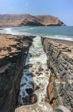 Ocean waves reaching the cliff Stock Photos