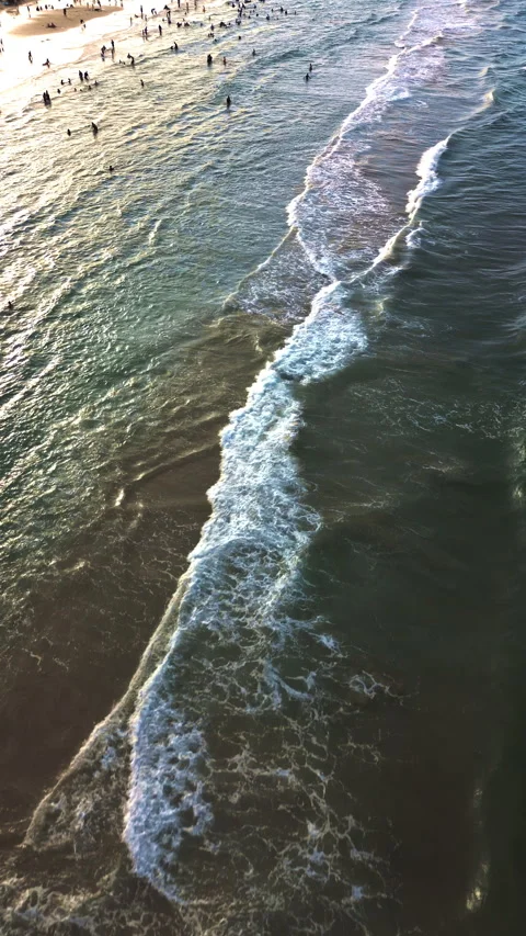 Ocean waves reaching the shore at sunset with calm coastal texture Stock Footage 341994130