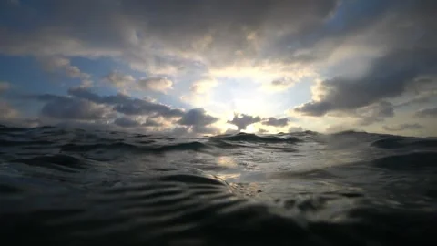 Ocean waves reflecting sunlight under cloudy sky Video stock 311713734
