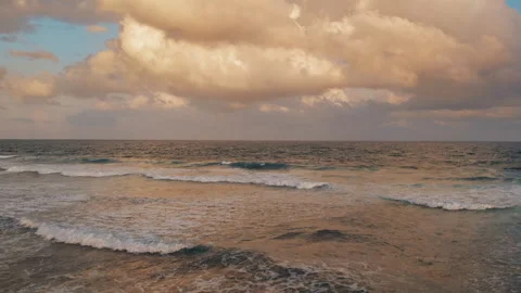 Ocean waves reflecting sunset light under dramatic clouds in Yucatan Mexico Stock Footage 315437050