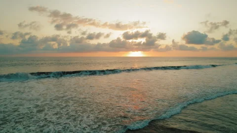 Ocean waves reflecting warm sunset colors on horizon in Costa Rica Stock Footage 327612462
