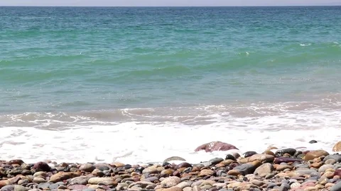 Ocean waves on rocks, Boat entering and exiting frame Stock Footage 78042617