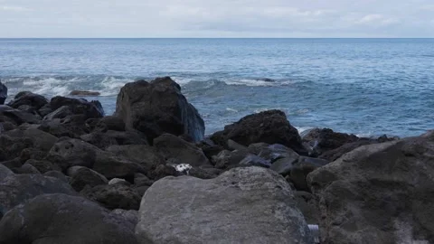 Ocean waves roll in and collide with a concrete pier, sending water splashing Stock Footage 346890198