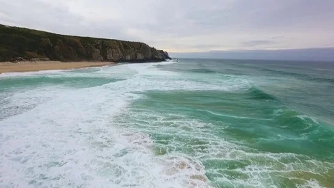 Ocean waves roll on a deserted autumn beach in the evening twilight Stock Footage 76839548