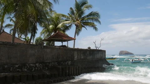 Ocean waves roll on seafront catamarans drift by beach Video stock 102487908