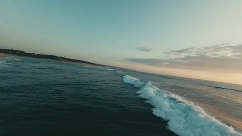 Ocean waves roll toward a golden-sand shore Stock Footage 340227668