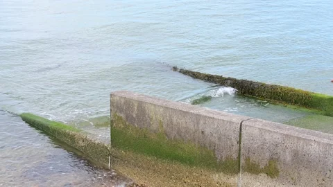 Ocean waves rolling against the jetty in Herne Bay Stock Footage 277960910