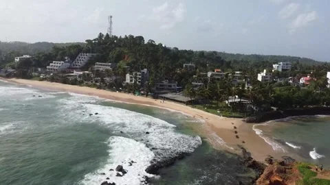Ocean waves rolling and breaking along picturesque Mirissa Beach Stock Footage 346569218