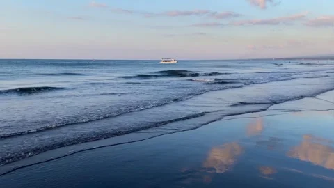 Ocean waves rolling on the beach with sky reflection in Bali Stock Footage 337857781
