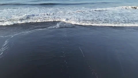 Ocean Waves Rolling Onto Black Volcanic Sand Beach Stock Footage 342543549