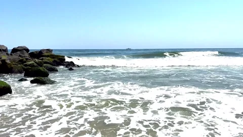 Ocean waves rolling on to a jetty at Asbury Park beach in New Jersey Stock Footage 340649415