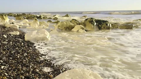 Ocean waves rolling over a rocky shore in slow-motion Stock Footage 265306183