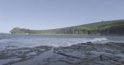 Ocean Waves Rolling Over Rocky Tidal Platform Near Green Headland Stock Footage 328200067