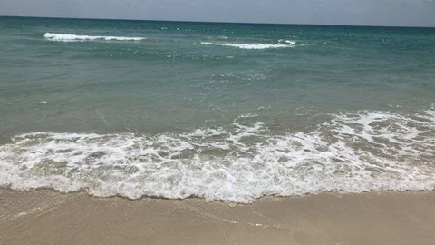 Ocean waves rolling on a sandy beach 스톡 동영상 107167530