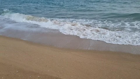 Ocean waves rolling onto sandy beach with soft coastal movement Stock Footage 321651139